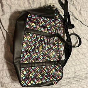 Luv Betsy rainbow duffle bag. Slip pocket on back to fit over luggage handle.